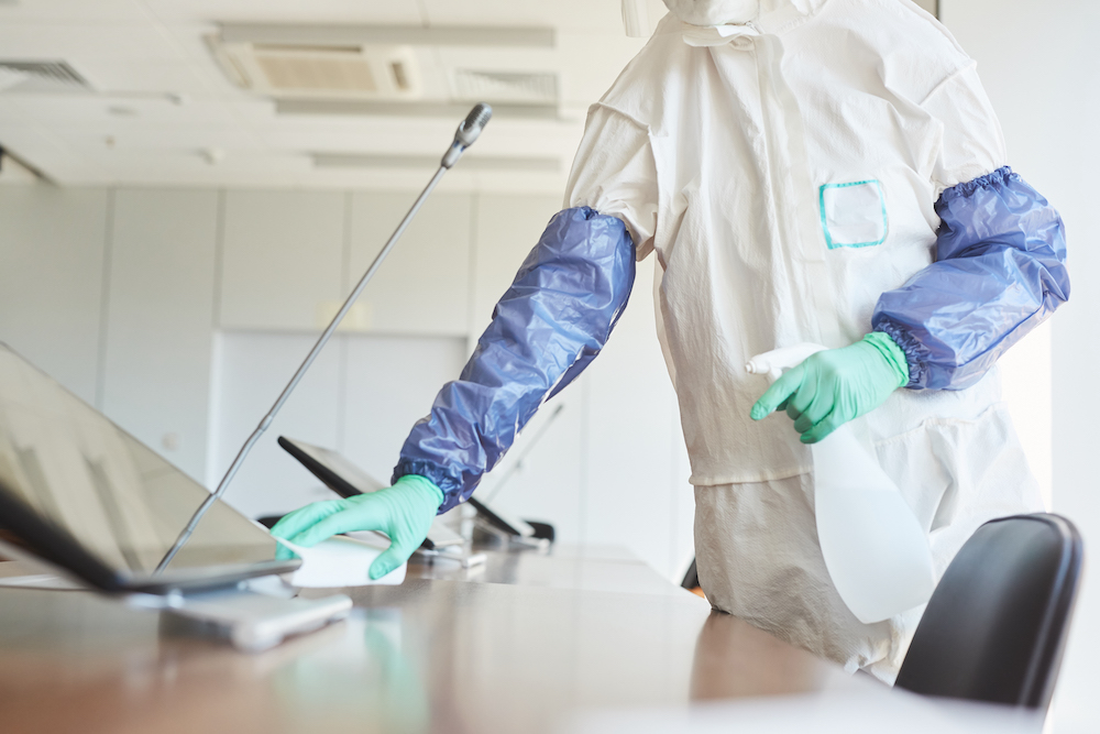 someone cleaning with hazmat gear